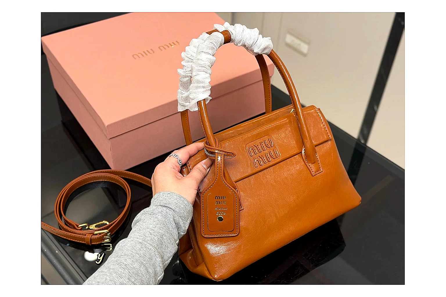 Prada Mini Top Handle Orange Brown comparison photo showing orange brown leather mini bag body, structured top handle, compact shape, and clean hardware details thumbnail 6
