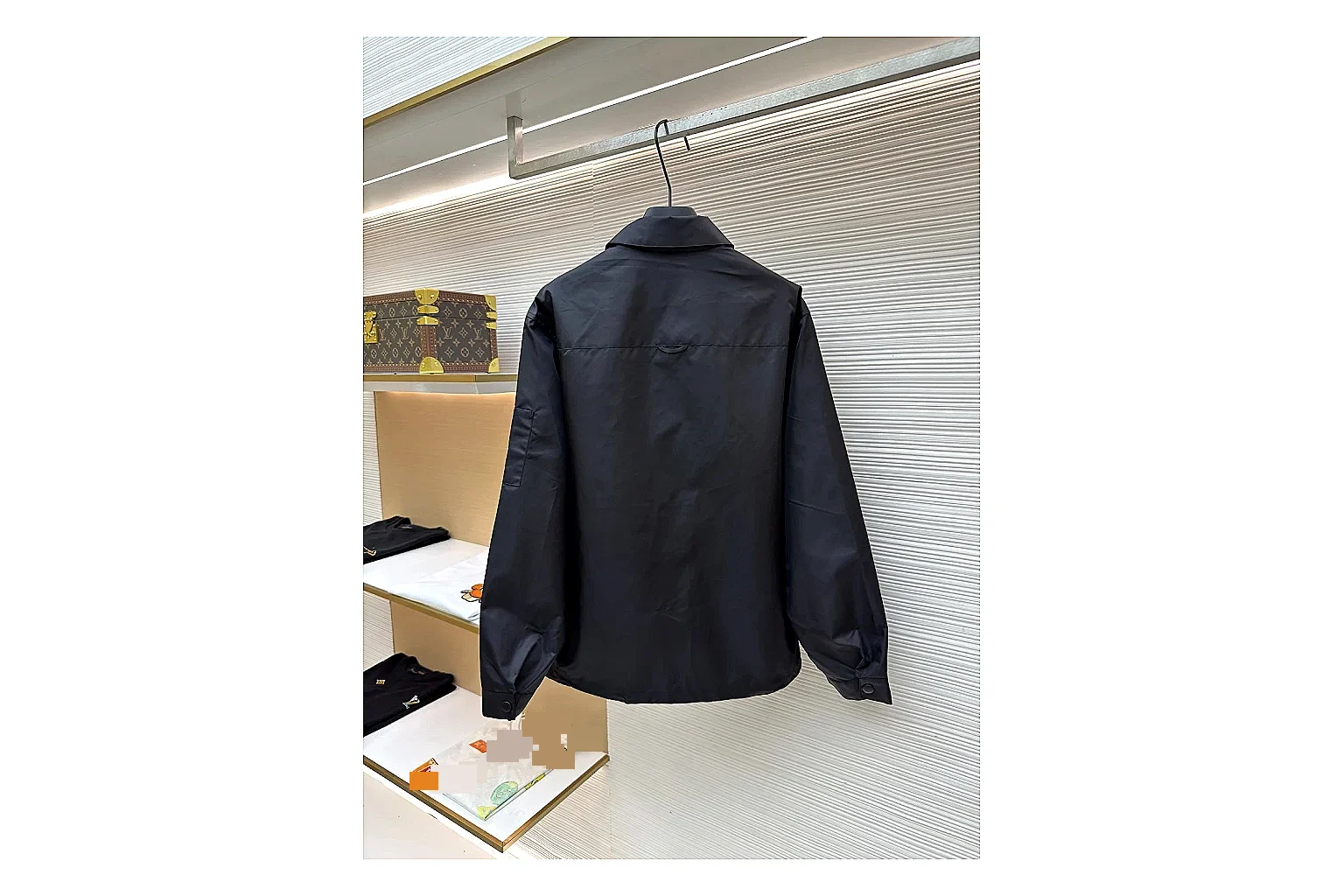 Prada Re-Nylon Hooded Jacket Black Jacket comparison signal photo with black Re-Nylon hooded jacket with recycled-nylon texture, hood structure, zipper line, sleeve cuffs, and light shell shape