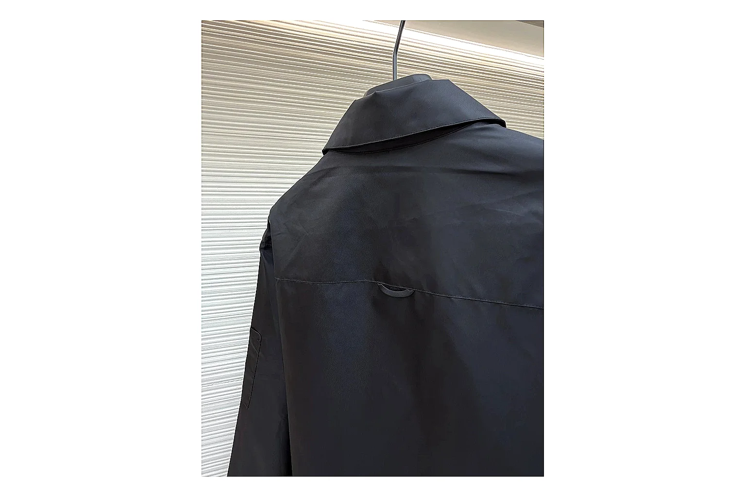 Prada Re-Nylon Hooded Jacket Black Jacket comparison signal photo with black Re-Nylon hooded jacket with recycled-nylon texture, hood structure, zipper line, sleeve cuffs, and light shell shape thumbnail 4