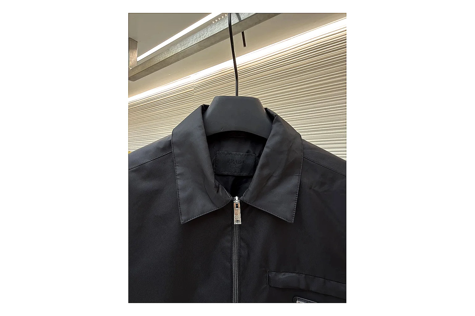 Prada Re-Nylon Hooded Jacket Black Jacket comparison signal photo with black Re-Nylon hooded jacket with recycled-nylon texture, hood structure, zipper line, sleeve cuffs, and light shell shape thumbnail 6